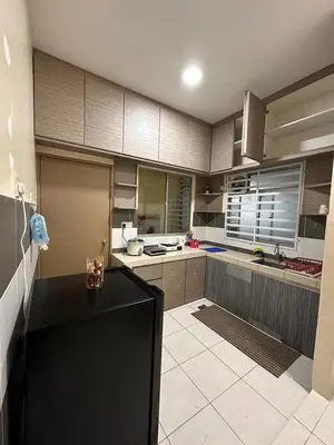 a large kitchen with a black counter in a room at StichStay Cameron in Tanah Rata