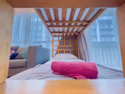 a bed with a pink towel on it in a room at Straits Quay By The Marina 1BR Family Suite in Tanjong Tokong