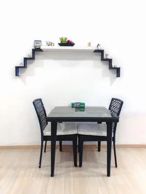 a table and two chairs in a room with stairs at 118 Island Plaza Seaview Family Suite 5Pax 1Carpark in George Town