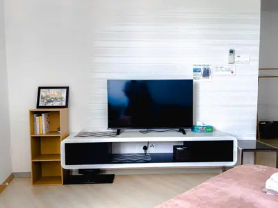 a flat screen tv sitting on a stand in a living room at 118 Island Plaza Seaview Family Suite 5Pax 1Carpark in George Town