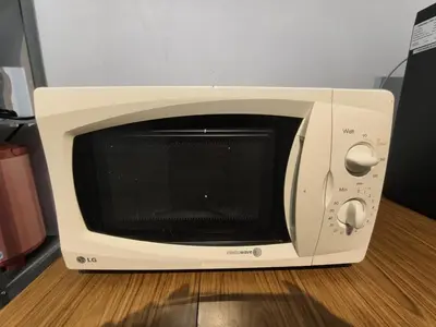 a microwave oven sitting on top of a table at Tanjung Bungah Holiday Home 4BR 20Pax 6Carpark in Tanjung Bungah