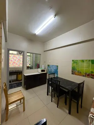 a kitchen and dining room with a table and chairs at Cameronian Lodge by AziziCameron in Tanah Rata
