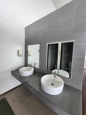 a bathroom with two sinks and two mirrors at Sunrise Gurney Spacious Comfort Suite - Penang Gurney Drive in George Town