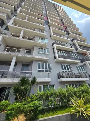 an apartment building with balconies and trees at The Octagon -The City Centre Signature Suite in Ipoh in Ipoh