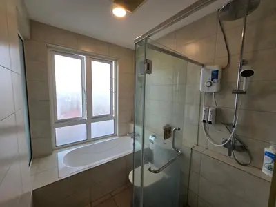 a bathroom with a shower and a toilet and a window at The Octagon -The City Centre Signature Suite in Ipoh in Ipoh