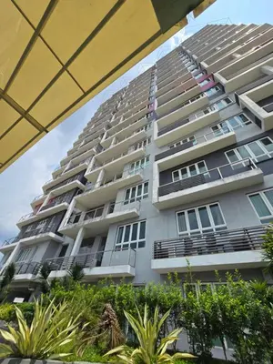 a tall apartment building with plants in front of it at The Octagon -The City Centre Signature Suite in Ipoh in Ipoh