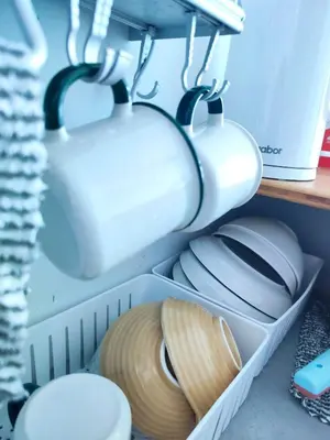 a drawer filled with white mugs and plates at Sunny Nest in Gopeng