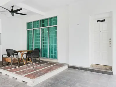 a dining room with a table and chairs and a window at Cozy Private Room for Relaxing Stays in Nibung Tebal
