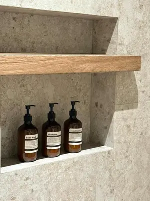 three bottles of soap are sitting on a shelf at Taiping Corner Homestay in Taiping