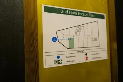 a sign on the side of a door with a floor escape plan at Le Dream Boutique Hotel in George Town