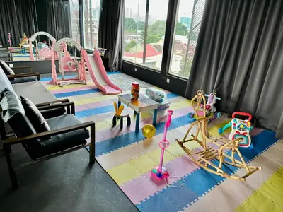 a living room with a play area with a playground at Le Dream Boutique Hotel in George Town