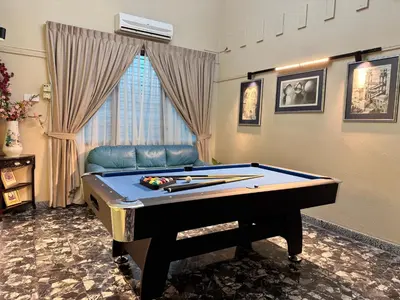 a room with a pool table and a couch at Greentown Villa - Ipoh City Centre near Ipoh Parade by IWH Suites in Ipoh