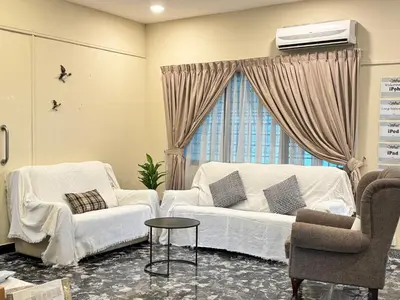 a living room with a white couch and two chairs at Greentown Villa - Ipoh City Centre near Ipoh Parade by IWH Suites in Ipoh