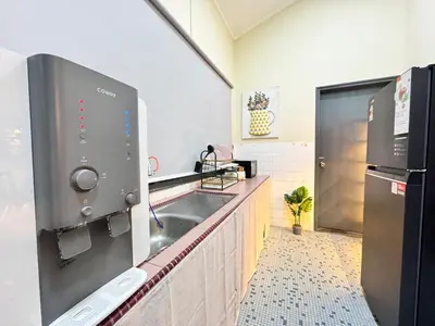 a kitchen with a sink and a refrigerator at Greentown Villa - Ipoh City Centre near Ipoh Parade by IWH Suites in Ipoh