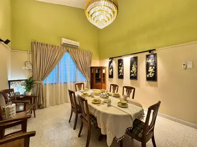 a dining room with a table and chairs and a chandelier at Greentown Villa - Ipoh City Centre near Ipoh Parade by IWH Suites in Ipoh