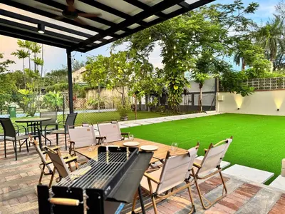 a patio with a table and chairs and a lawn at Ruyu 44 TownVilla 5R4B 18pax Bbq KTV Pool Table in Ipoh