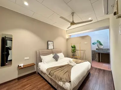 a bedroom with a bed and a ceiling fan at Ruyu 44 TownVilla 5R4B 18pax Bbq KTV Pool Table in Ipoh