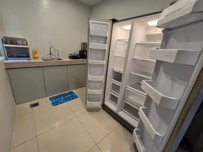 a refrigerator with its doors open in a kitchen at Manhattan Condo - Ipoh Merveille Luxe Stay in Ipoh