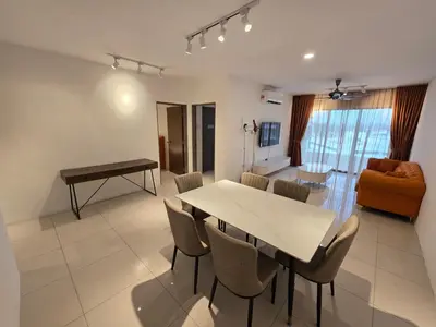 a dining room and living room with a table and chairs at Manhattan Condo - Ipoh Merveille Luxe Stay in Ipoh
