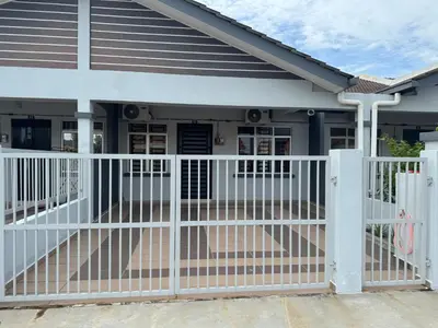 a white fence in front of a house at Sour'd Staycation Near Teluk Senangin Beach in Kampong Batu Tiga