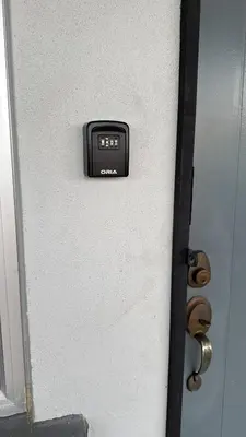 a door with a clock on the side of it at Sour'd Staycation Near Teluk Senangin Beach in Kampong Batu Tiga