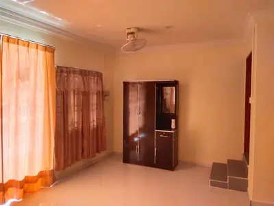 a living room with a refrigerator and a window at Teratak Desa Cemerlang 3 in Kuala Kangsar