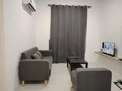 a living room with two chairs and a table at CK Homestay in Ipoh