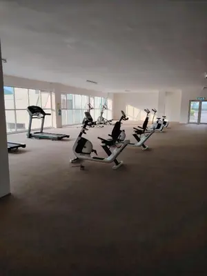 a gym with several treadmills in a large room at CK Homestay in Ipoh
