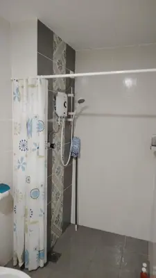 a bathroom with a shower with a shower curtain at CK Homestay in Ipoh