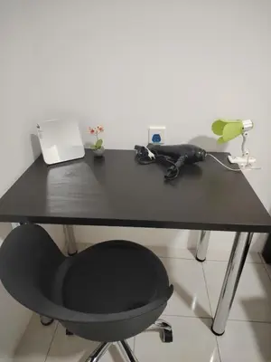 a black desk with a chair and a phone at CK Homestay in Ipoh