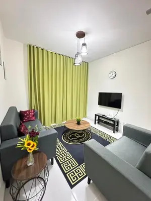 a living room with a couch and a tv at Zaleha Homestay in Brinchang