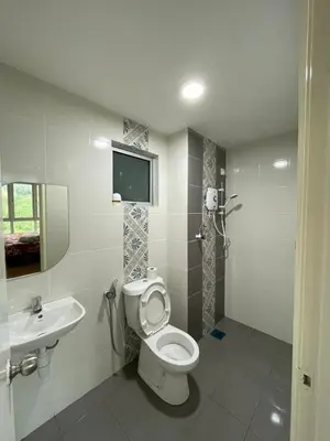 a bathroom with a toilet and a sink at Ipoh Anderson Residence in Ipoh