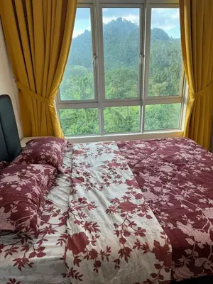 a bed in a room with a large window at Ipoh Anderson Residence in Ipoh