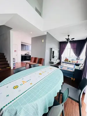 a bedroom with a large bed and a living room at AYAAN Foosball Penthouse at Golden Hill with Private Parking and Netflix in Brinchang