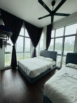 a bedroom with two beds and a ceiling fan at AYAAN Foosball Penthouse at Golden Hill with Private Parking and Netflix in Brinchang