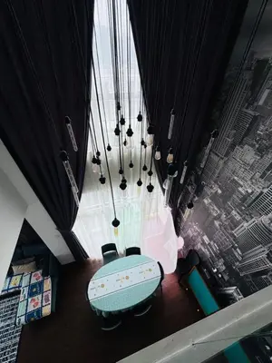 a table and chairs in a room with a large window at AYAAN Foosball Penthouse at Golden Hill with Private Parking and Netflix in Brinchang