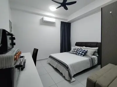 a bedroom with a bed and a ceiling fan at Sinaran Residences in Batu Kawan