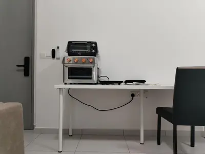 a toaster oven sitting on top of a table at Sinaran Residences in Batu Kawan