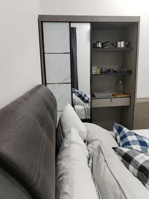 a living room with a couch and some shelves at Sinaran Residences in Batu Kawan