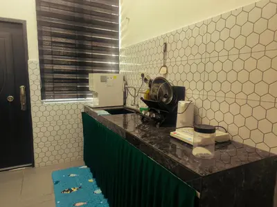 a kitchen with a counter with a appliance on it at damai homestay - feel like a home in Sitiawan