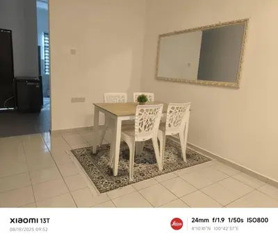 a dining room table with two chairs and a mirror at damai homestay - feel like a home in Sitiawan