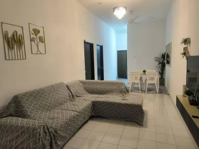 a bedroom with a bed and a table in it at damai homestay - feel like a home in Sitiawan
