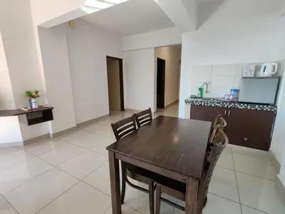 a kitchen and dining room with a wooden table and chairs at KIMNA HOME at MARINA HEIGHT in Lumut