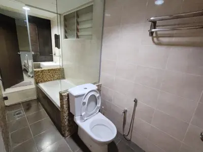 a bathroom with a toilet and a bath tub at KIMNA HOME at MARINA HEIGHT in Lumut