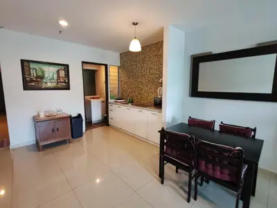 a kitchen with a table and two benches in a room at KIMNA HOME at MARINA HEIGHT in Lumut