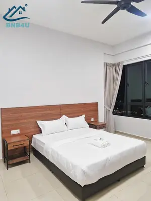 a bedroom with a large bed with a ceiling fan at Minimalist Dual-Key Stay with 4BR at Farlim Penang in Ayer Itam