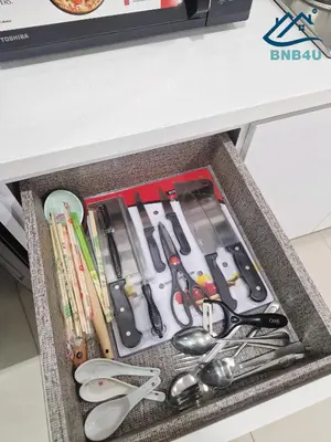 a drawer filled with lots of cooking utensils at Minimalist Dual-Key Stay with 4BR at Farlim Penang in Ayer Itam