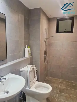 a bathroom with a toilet and a sink at Minimalist Dual-Key Stay with 4BR at Farlim Penang in Ayer Itam