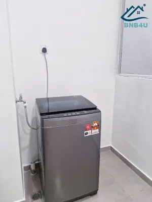 a small refrigerator in a corner of a room at Minimalist Dual-Key Stay with 4BR at Farlim Penang in Ayer Itam