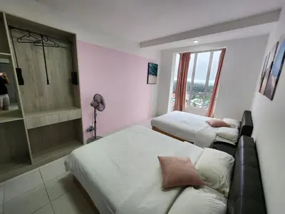 a hotel room with two beds and a window at Sweet Home G12 Emerald Avenue in Brinchang